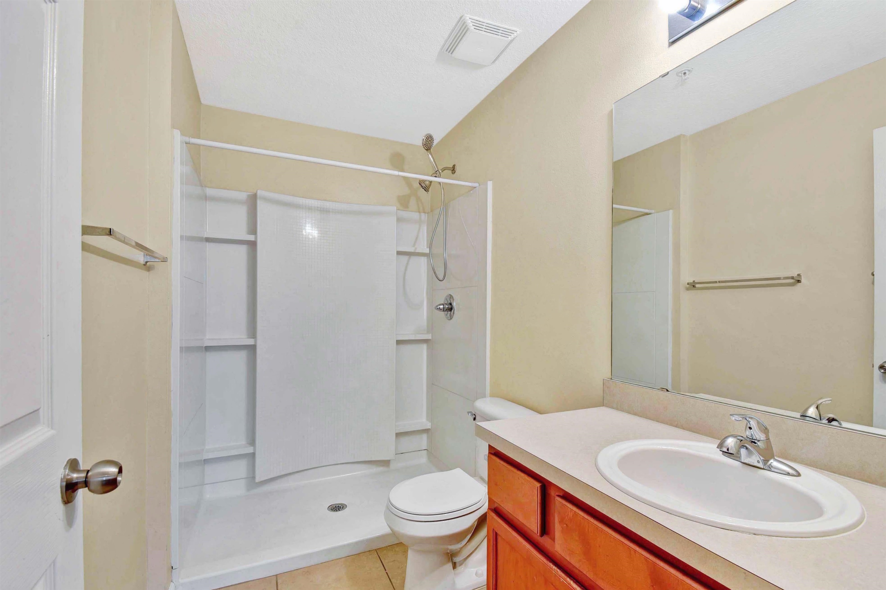 617 Golden Lake Loop St. Augustine, FL 32084 - Photo 18 of 25 a bathroom with a sink toilet and shower