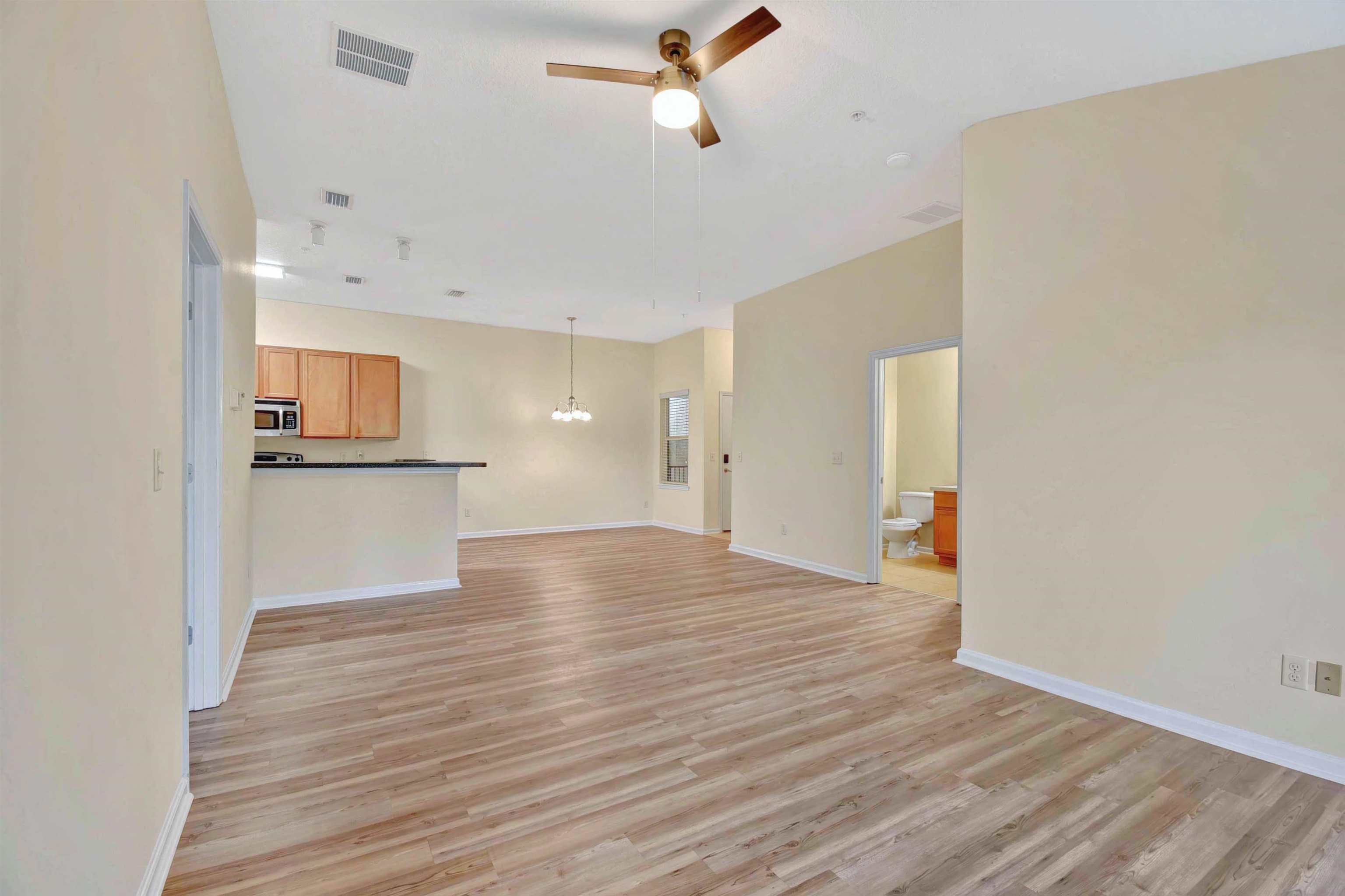 617 Golden Lake Loop St. Augustine, FL 32084 - Photo 19 of 25 a view of a kitchen with a fridge and wooden floor