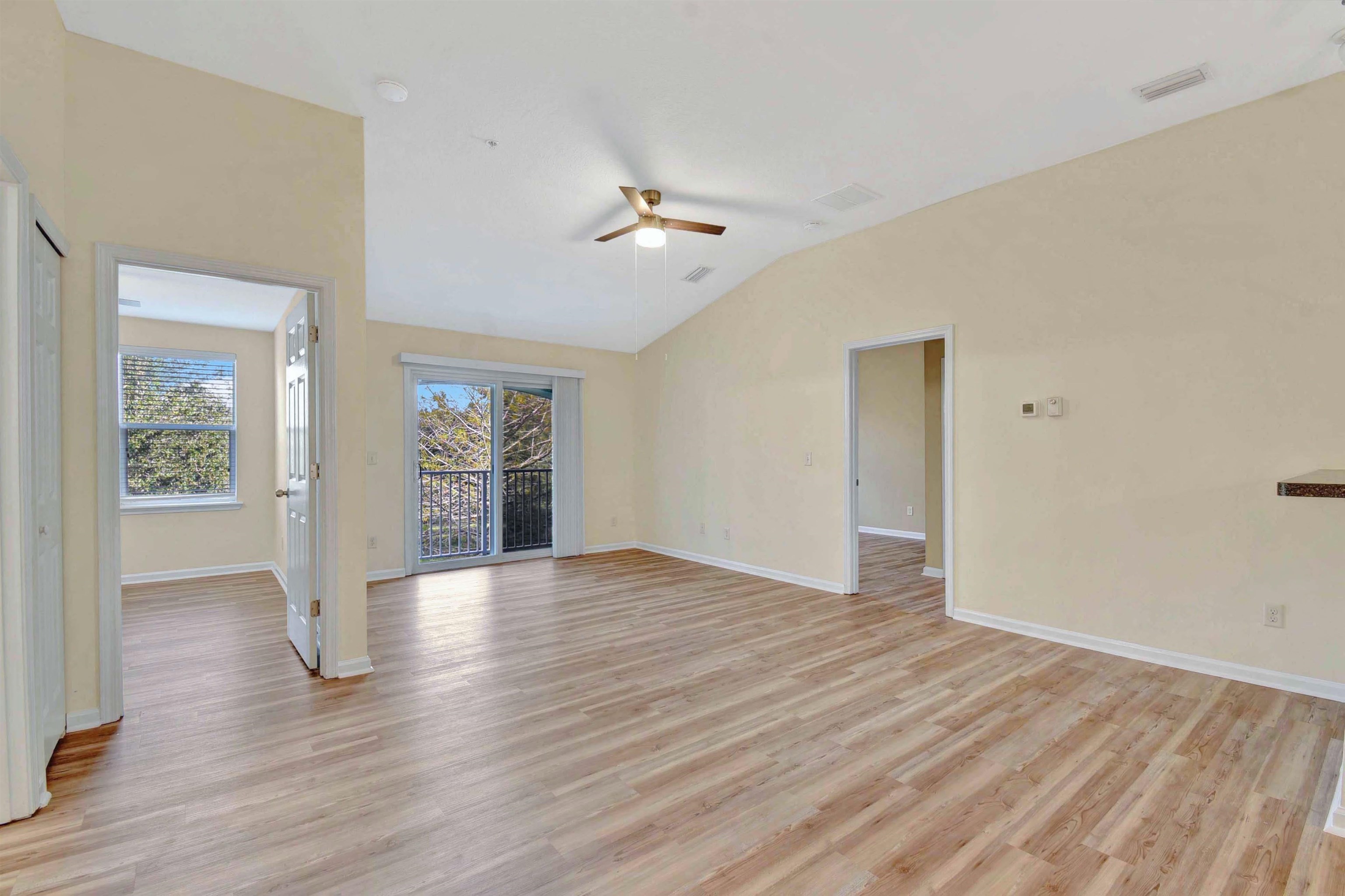 617 Golden Lake Loop St. Augustine, FL 32084 - Photo 21 of 25 a view of an empty room with wooden floor and a ceiling fan