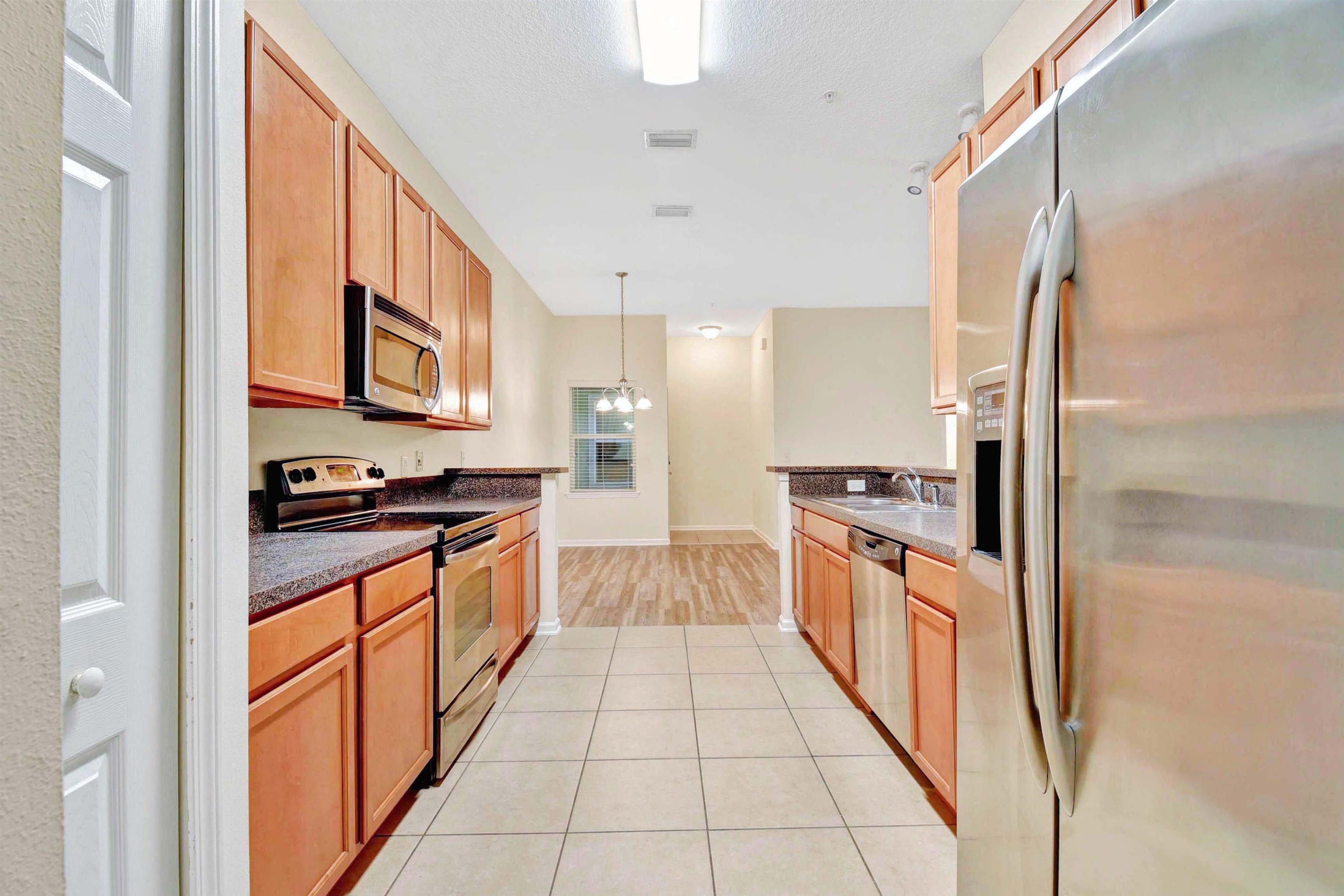 617 Golden Lake Loop St. Augustine, FL 32084 - Photo 9 of 25 a large kitchen with stainless steel appliances granite countertop a stove and a refrigerator