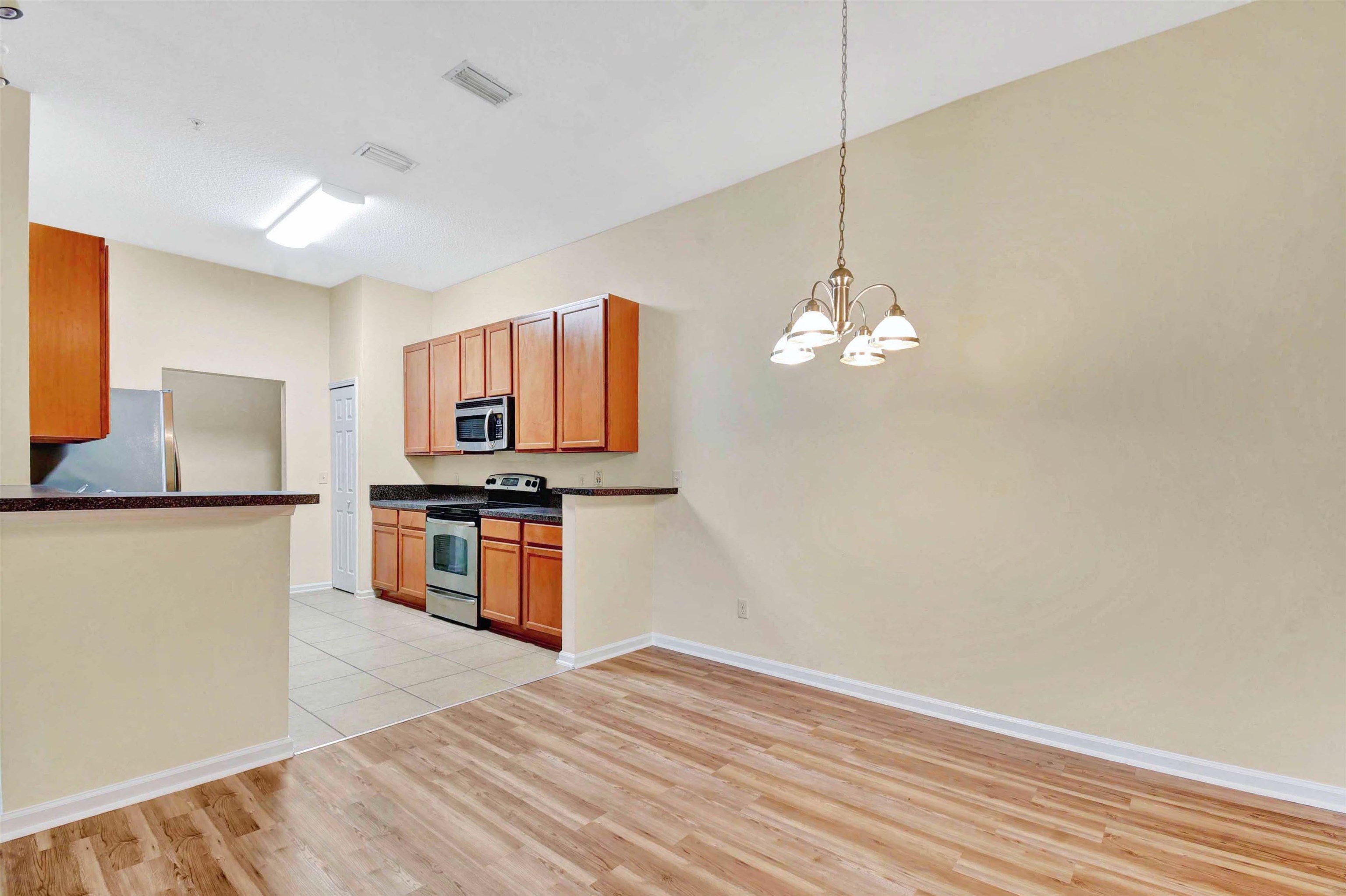 617 Golden Lake Loop St. Augustine, FL 32084 - Photo 10 of 25 a kitchen with stainless steel appliances granite countertop a refrigerator a stove and a sink