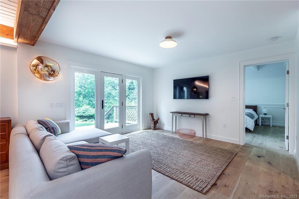 147 Wykeham Road Washington, CT 06793 - Photo 20 of 40 Family room w/doors leading to deck and primary bedroom.