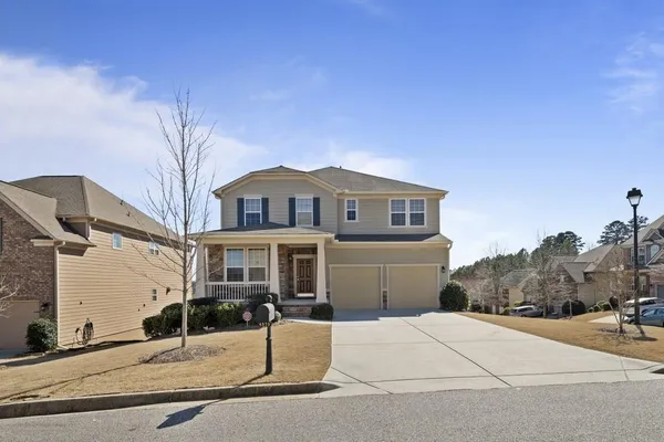 a front view of a house with a yard and garage