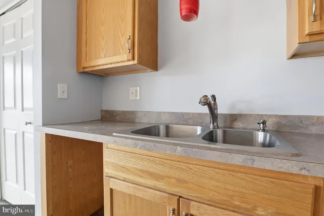 a kitchen with sink and cabinets