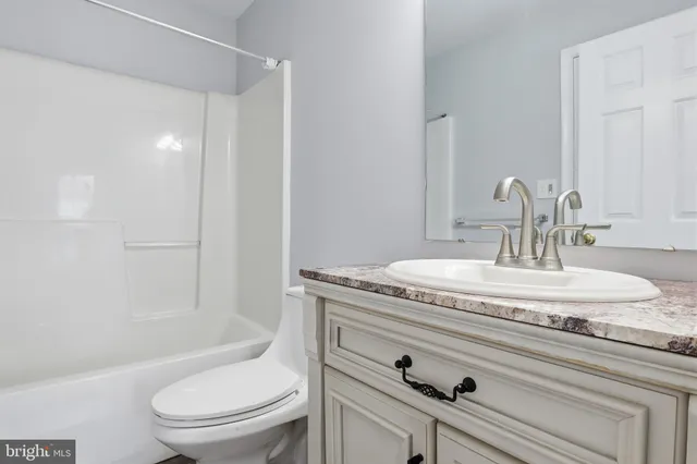 a bathroom with a shower sink and mirror