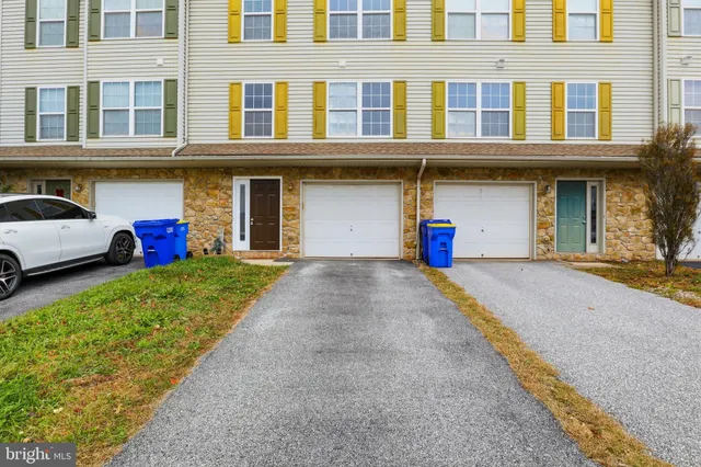 a front view of a building with a yard