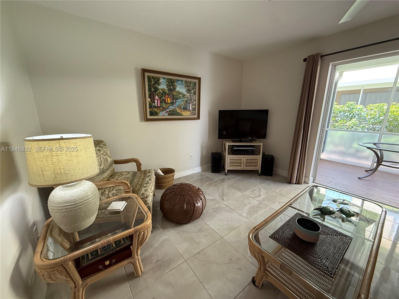 417 Waterside Drive Hypoluxo, FL 33462 - Photo 12 of 52 a living room with furniture and a flat screen tv