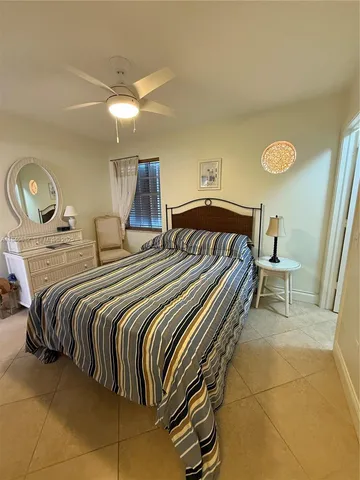 a bedroom with a bed and a lamp