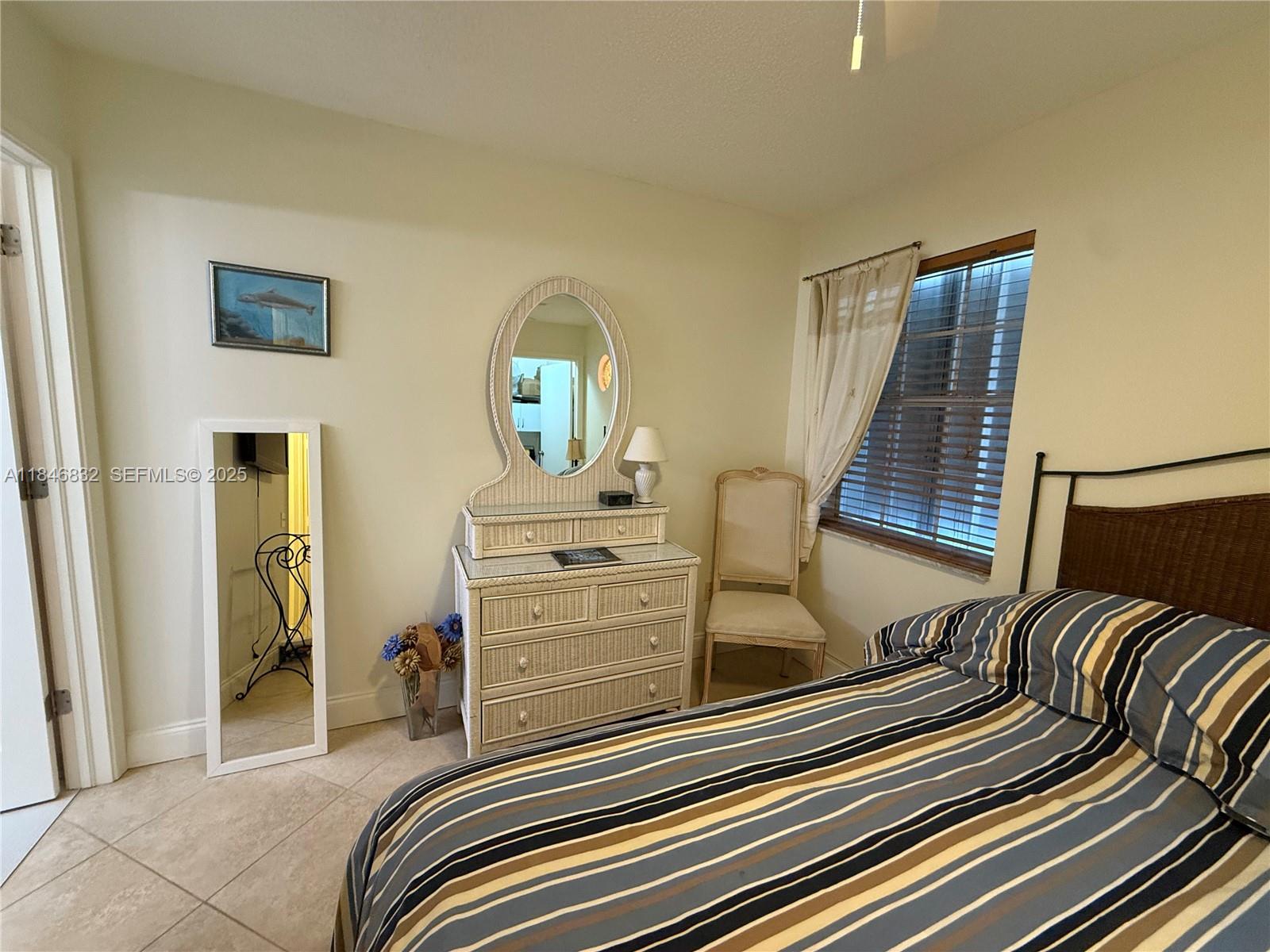 417 Waterside Drive Hypoluxo, FL 33462 - Photo 17 of 52 a bedroom with a bed and a dresser