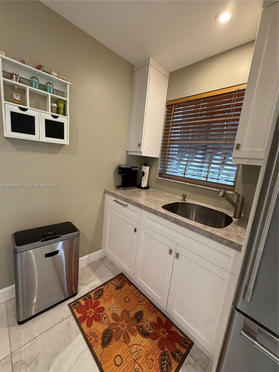 417 Waterside Drive Hypoluxo, FL 33462 - Photo 2 of 52 a kitchen with stainless steel appliances kitchen island granite countertop a stove a sink and a microwave