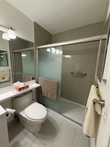 a bathroom with a toilet a sink and shower