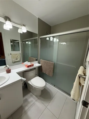 a bathroom with a sink mirror vanity and toilet