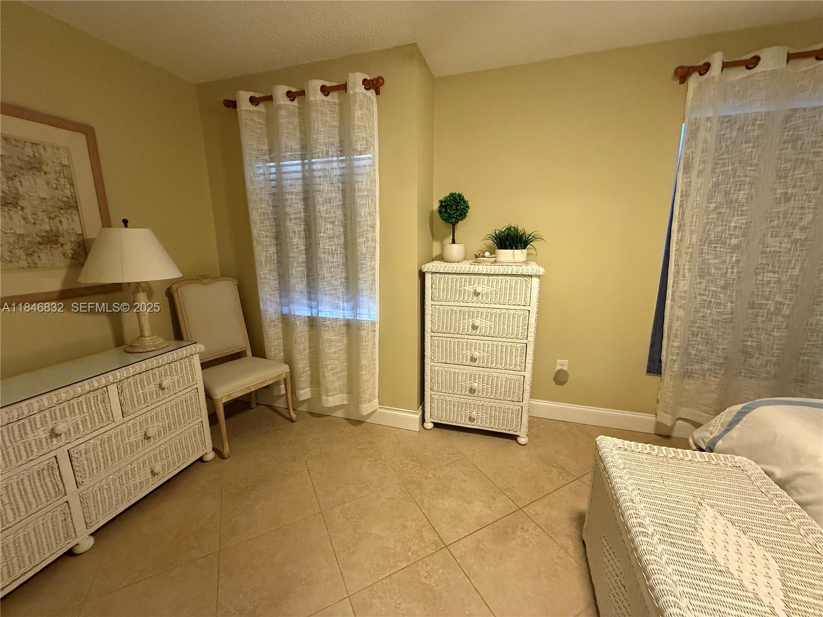 417 Waterside Drive Hypoluxo, FL 33462 - Photo 27 of 52 a bedroom with a bed and a dresser