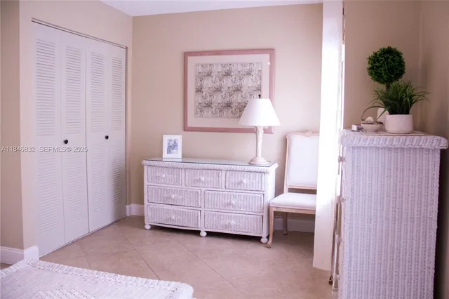a spacious bedroom with a bed and a cabinets