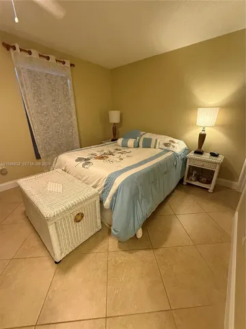 a bathroom with a granite countertop toilet sink and mirror
