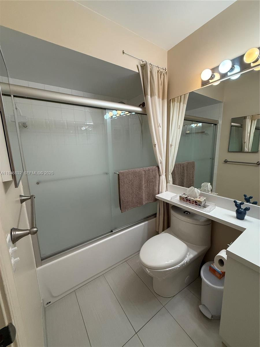 417 Waterside Drive Hypoluxo, FL 33462 - Photo 31 of 52 a bathroom with a granite countertop toilet sink and mirror