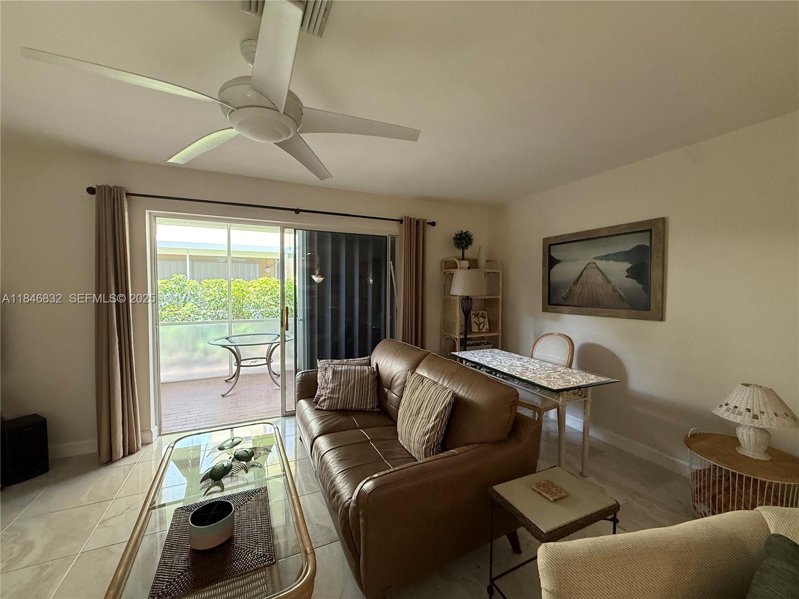 417 Waterside Drive Hypoluxo, FL 33462 - Photo 37 of 52 a living room with furniture and a large window