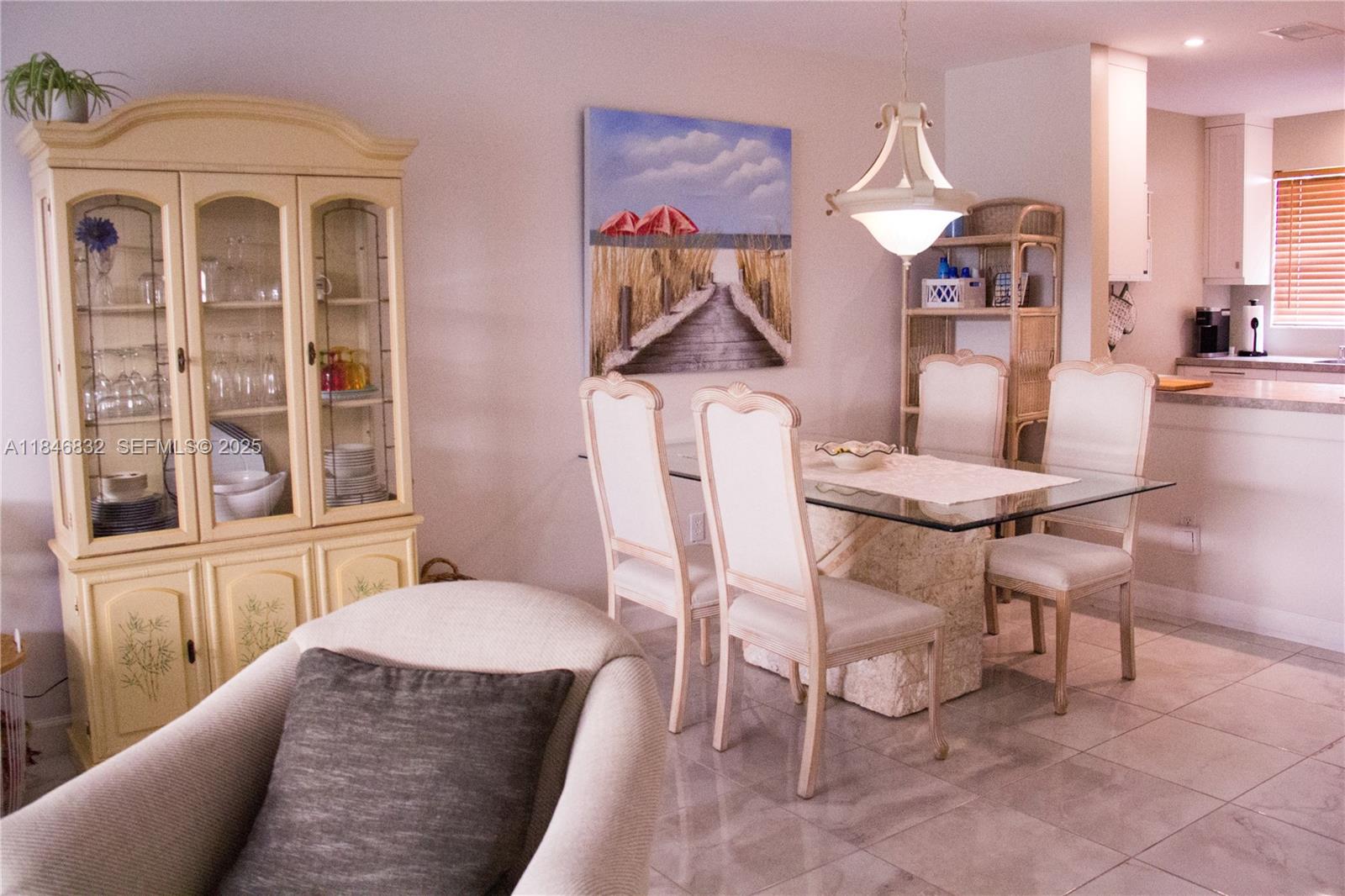 417 Waterside Drive Hypoluxo, FL 33462 - Photo 44 of 52 a view of a dining room with furniture and a window