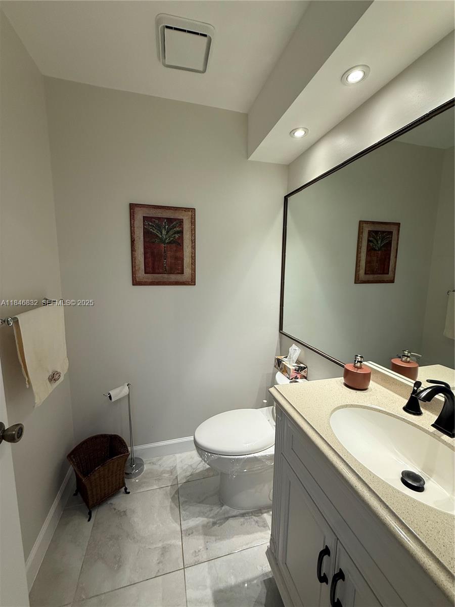 417 Waterside Drive Hypoluxo, FL 33462 - Photo 9 of 52 a bathroom with a toilet sink and mirror