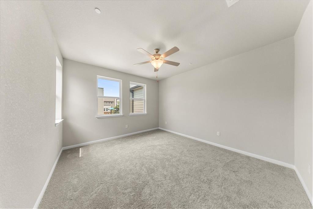 9015 Cattle Baron Path, Unit 1502 Austin, TX 78747 - Photo 9 of 31 Spare room with a ceiling fan and light carpet