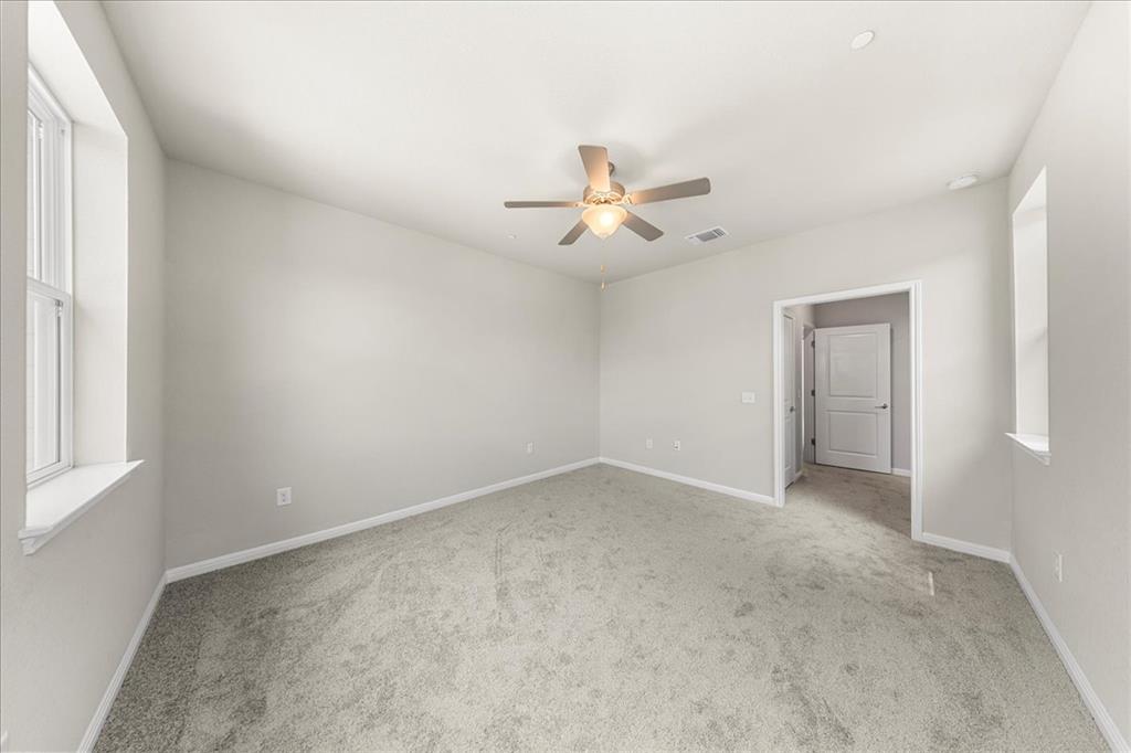 9015 Cattle Baron Path, Unit 1502 Austin, TX 78747 - Photo 12 of 31 Unfurnished room featuring light colored carpet and a ceiling fan