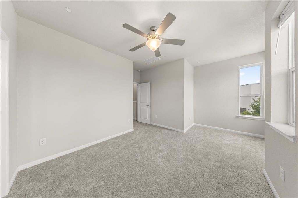 9015 Cattle Baron Path, Unit 1502 Austin, TX 78747 - Photo 15 of 31 Carpeted empty room with baseboards and a ceiling fan