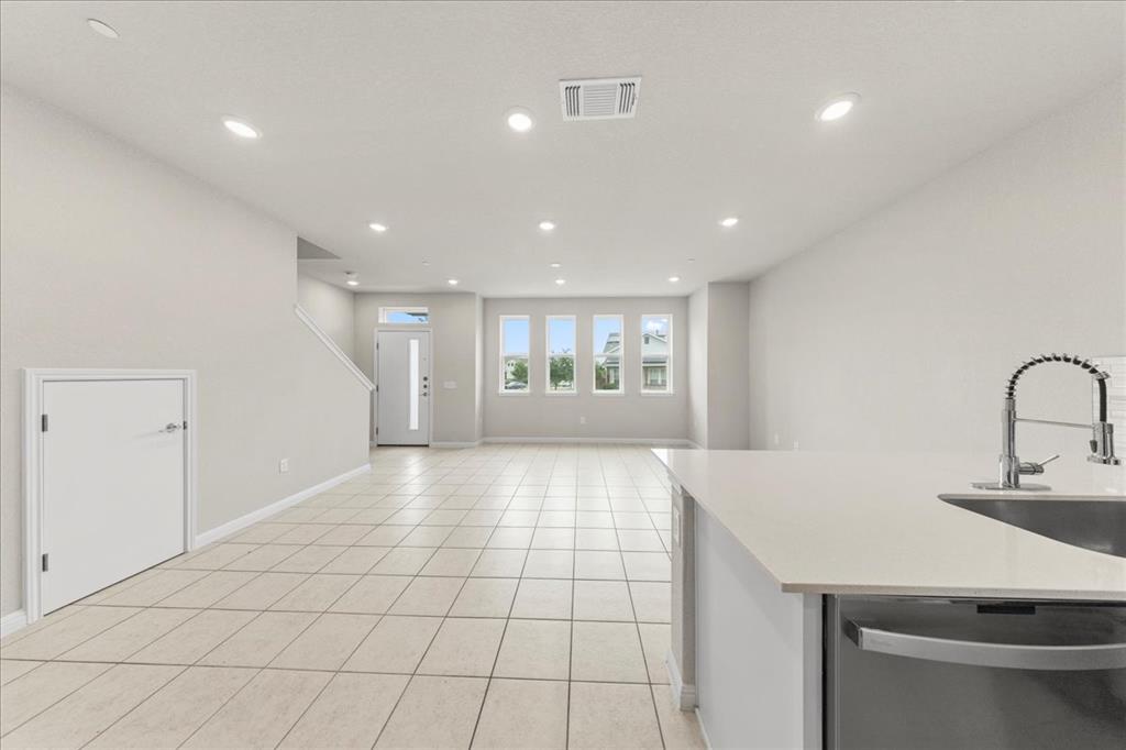 9015 Cattle Baron Path, Unit 1502 Austin, TX 78747 - Photo 21 of 31 Unfurnished living room with light tile patterned flooring and recessed lighting