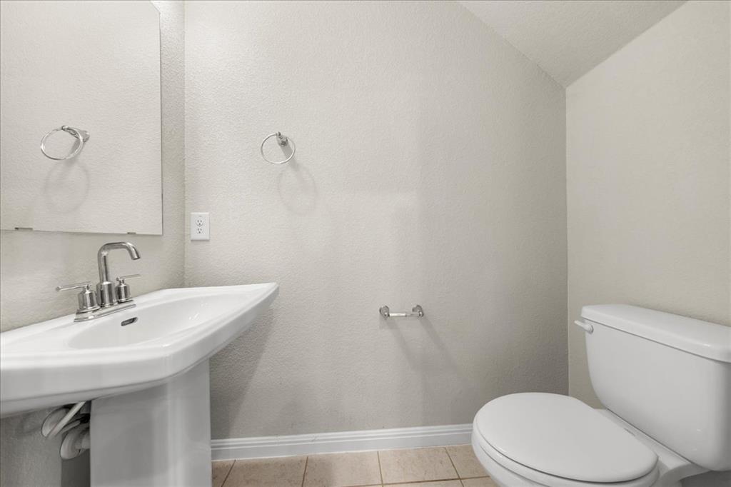 9015 Cattle Baron Path, Unit 1502 Austin, TX 78747 - Photo 23 of 31 Bathroom with light tile patterned floors and lofted ceiling