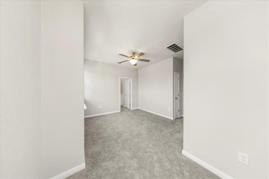 9015 Cattle Baron Path, Unit 1502 Austin, TX 78747 - Photo 26 of 32 Empty room with light colored carpet and a ceiling fan