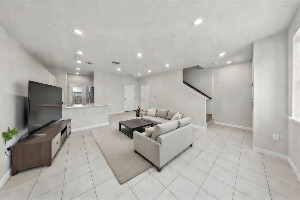 9015 Cattle Baron Path, Unit 1502 Austin, TX 78747 - Photo 2 of 31 Living area with recessed lighting and light tile patterned flooring