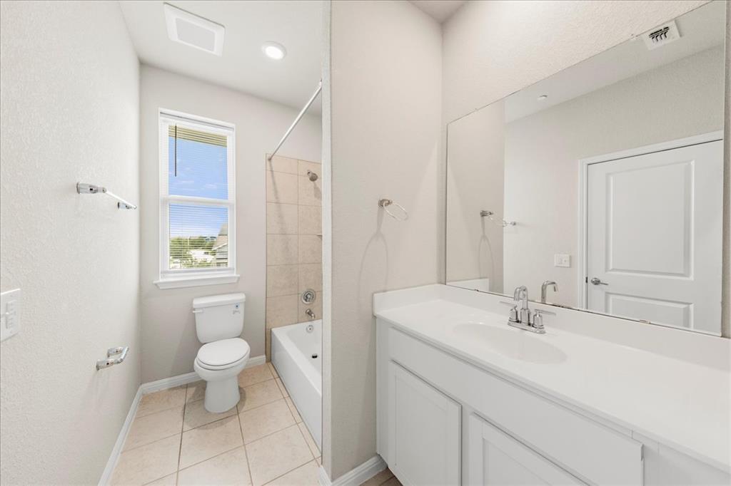 9015 Cattle Baron Path, Unit 1502 Austin, TX 78747 - Photo 8 of 31 Full bathroom with bathing tub / shower combination, vanity, and light tile patterned flooring