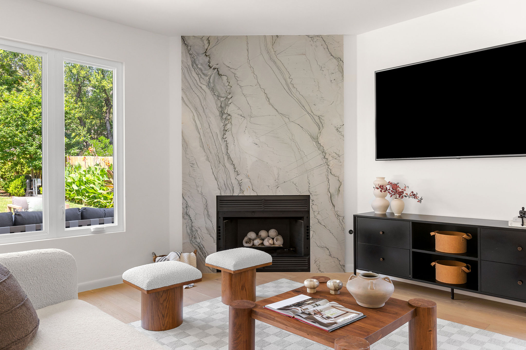 6500 Clay Allison Pass Austin, TX 78749 - Photo 11 of 39 Modern living area featuring a floor-to-ceiling fireplace with a decorative stone surround and a dark-finished firebox