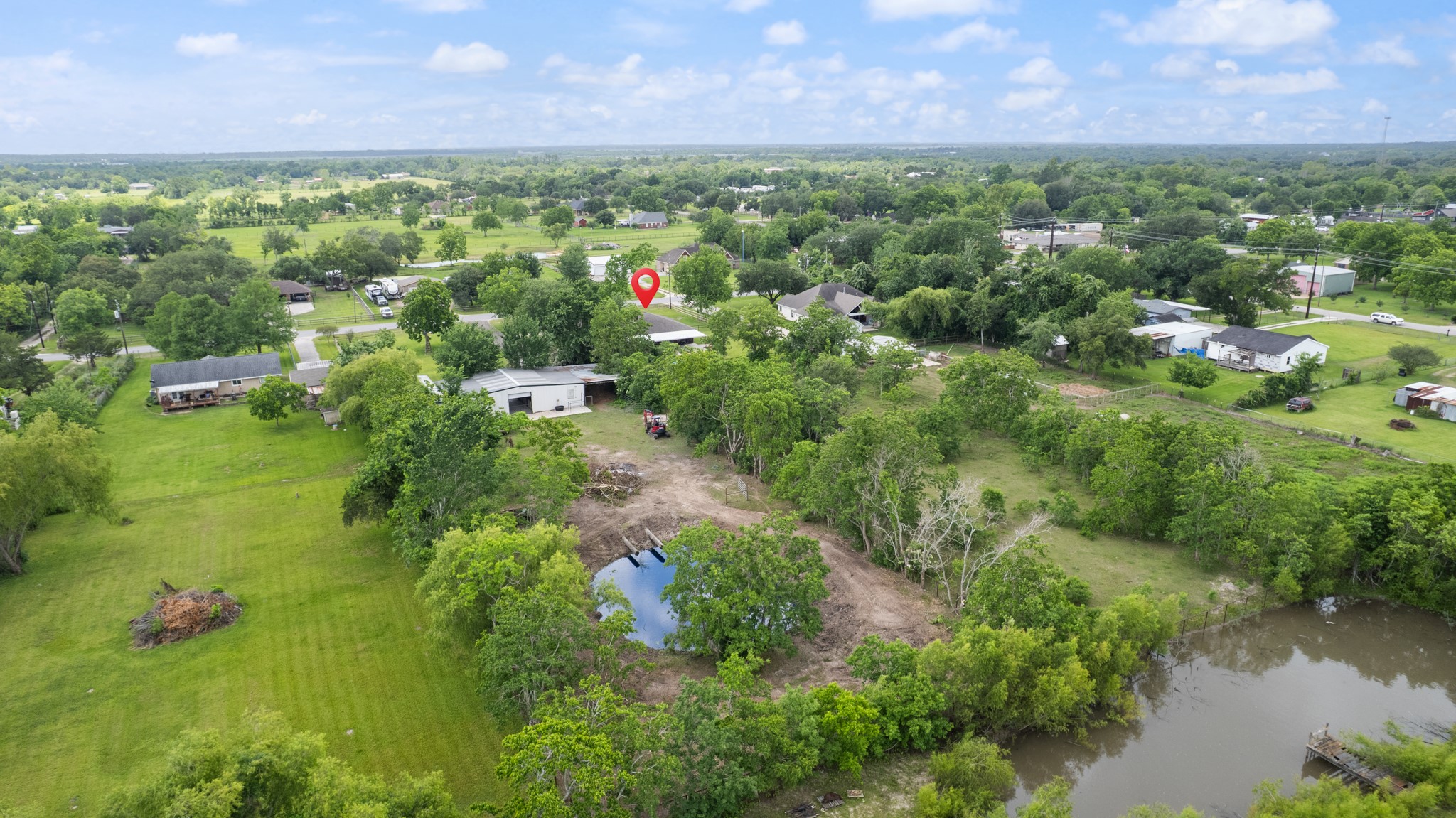 15602 Fir Road Santa Fe, TX 77517 - Photo 41 of 42 Sweeping aerial perspective highlighting the property’s expansive grounds, mature trees, open pasture areas, and additional land features. Ideal for those seeking extra space, privacy, and room for livestock, recreation, or future projects.