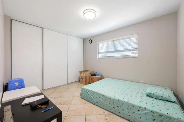 a bedroom with a bed and a dresser