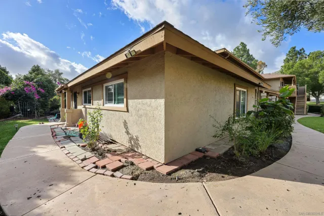 a backyard of a house with plants and trees
