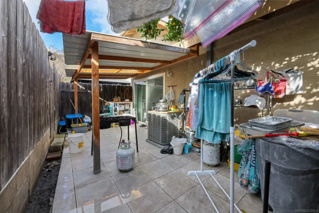 a living room with furniture and a dining table with kitchen view