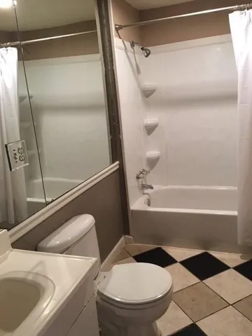 a bathroom with a toilet and a shower