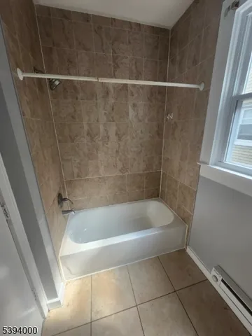 a bath tub sitting next to a shower