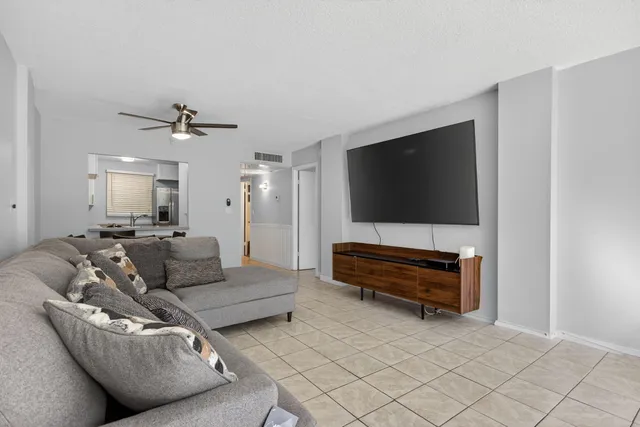 an empty room with closet and a chandelier fan