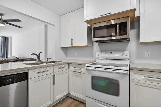 a kitchen with a sink cabinets and window