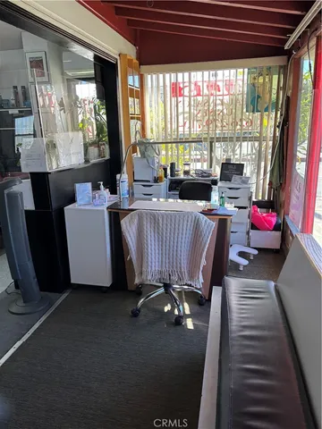a living room with furniture and a floor to ceiling window