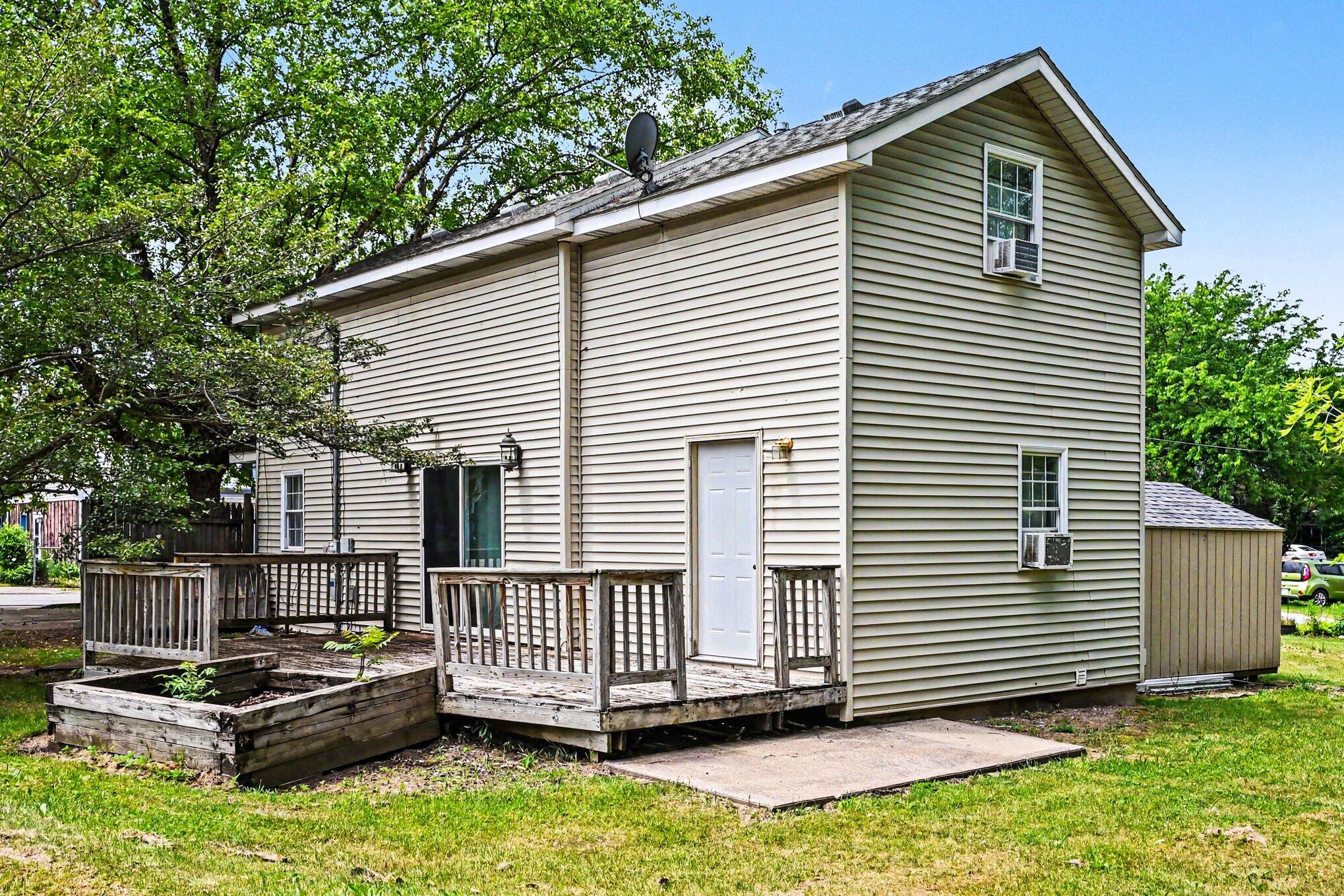 115 McClung Road La Porte, IN 46350 - Photo 21 of 31 a view of a white house with a small deck and furniture