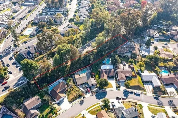 an aerial view of residential houses with outdoor space