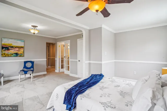 a bedroom with a bed and painting on the wall