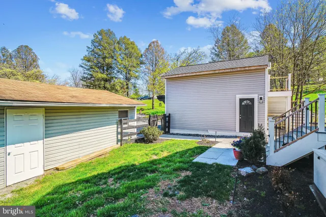a view of a house with a yard and sitting area