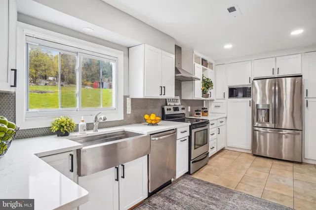 a kitchen with a sink cabinets and stainless steel appliances