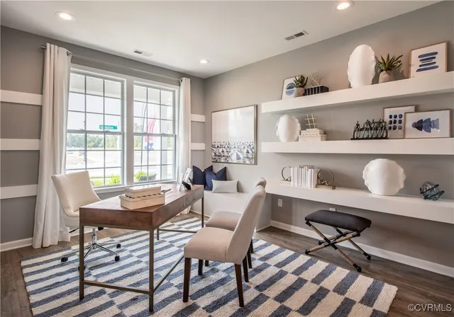 a view of a dining room with furniture and a window