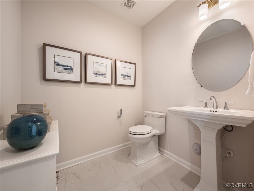 Undisclosed Address Chester, VA 23831 - Photo 12 of 33 a bathroom with a toilet a sink and mirror