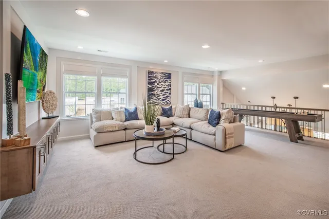 a living room with furniture and a table with wooden floor