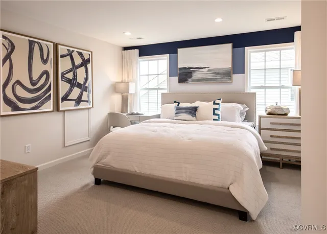 a spacious bedroom with a bed and a window